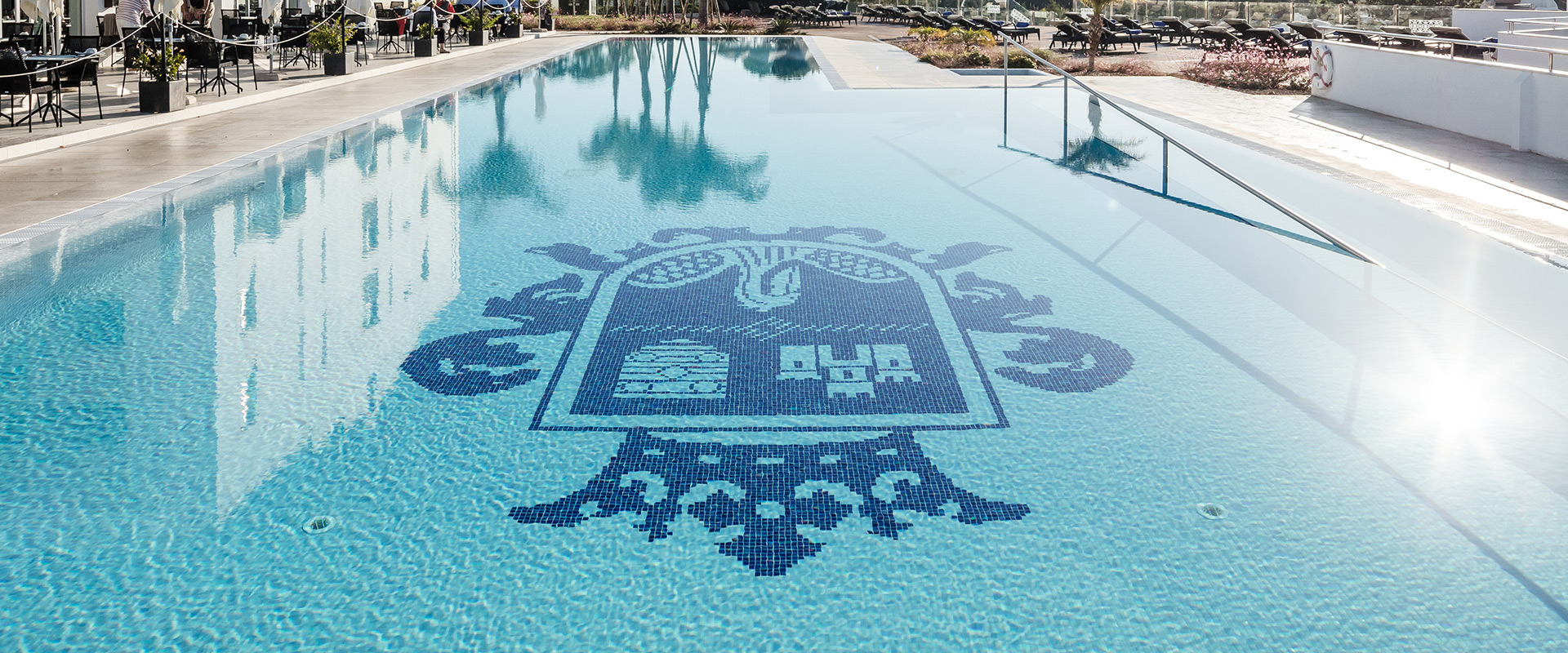 Dona Filipa Hotel mosaic logo crest in the swimming pool