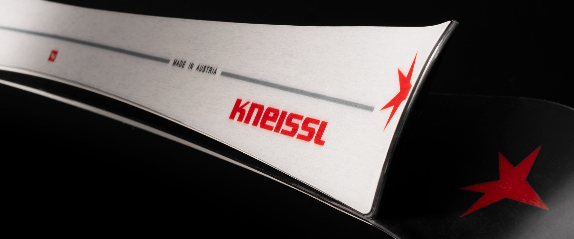 Kneissl White Star ski image on reflective surface