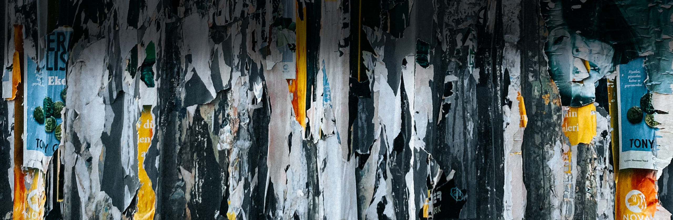 Old and torn branded posters showing how transient graphic design can be